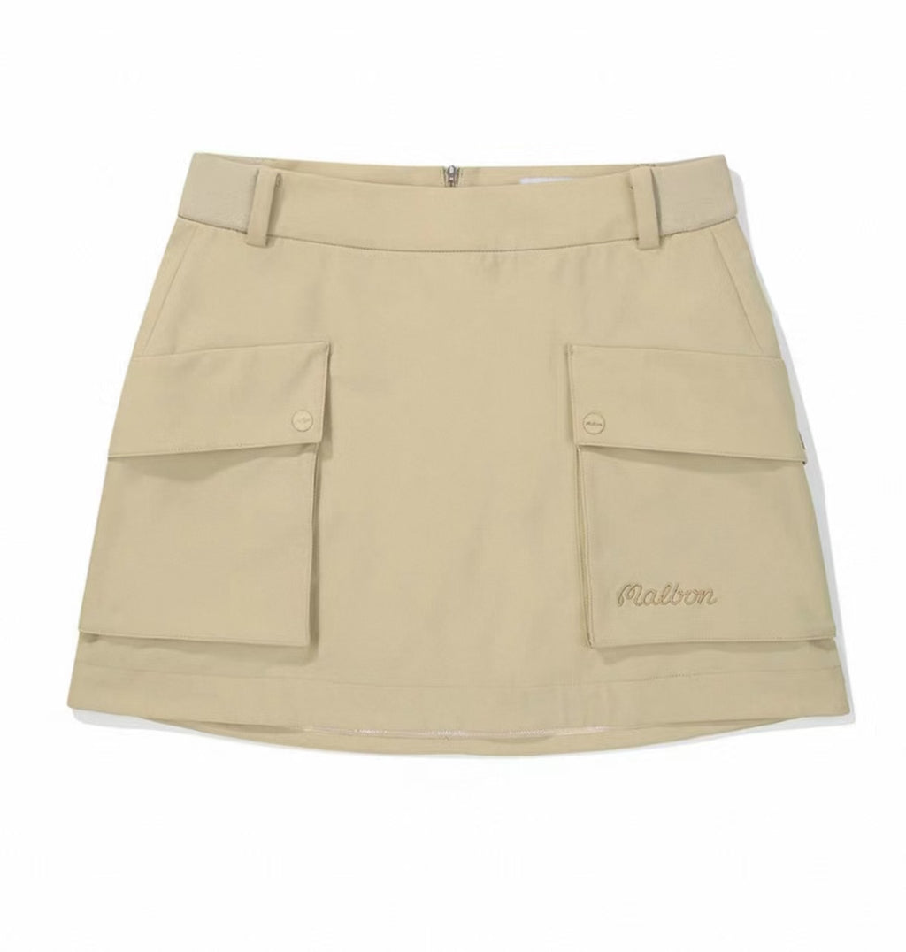 Malbon women's solid pleated golf skort with pockets in Khaki, front view