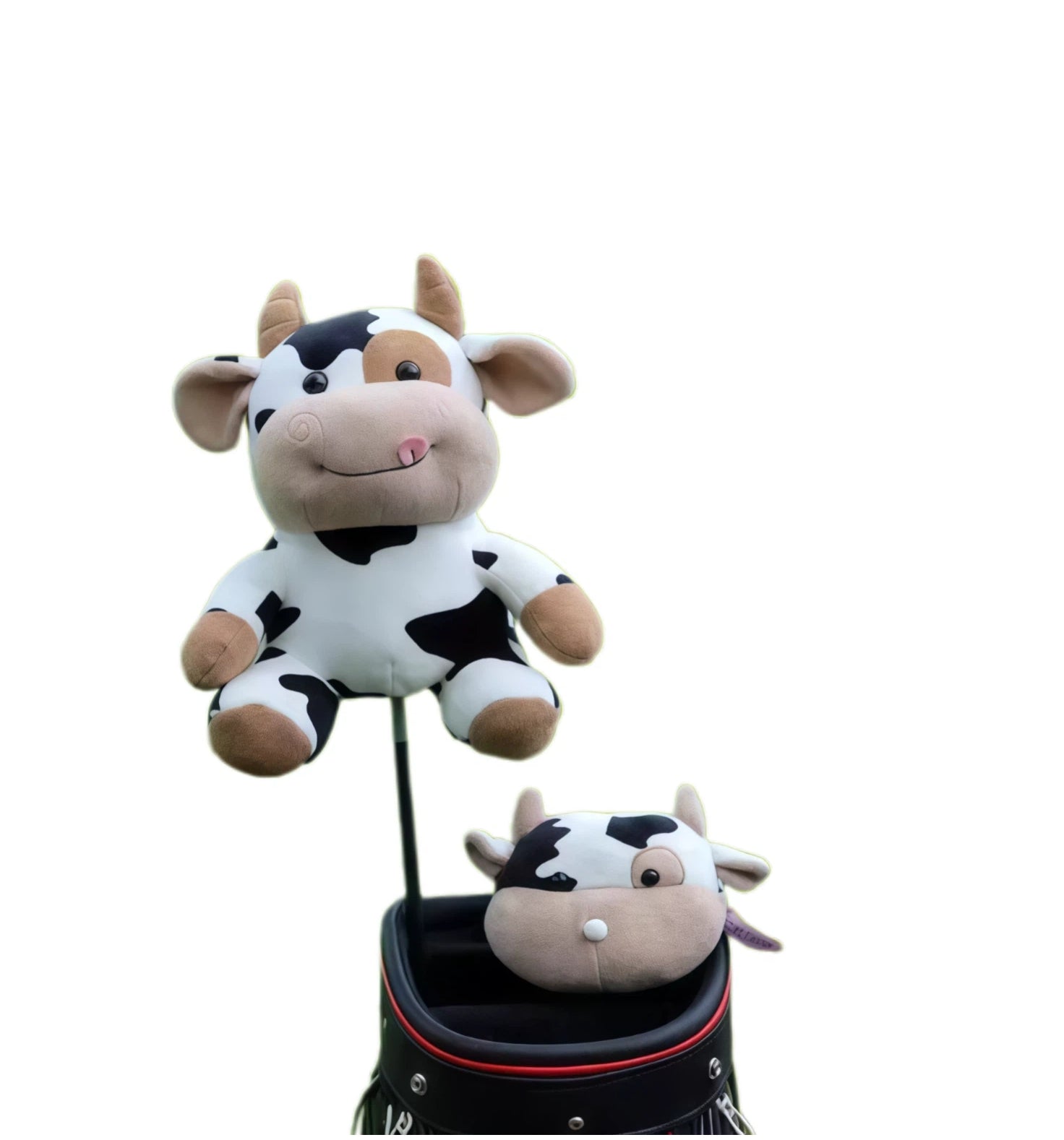 Two cow plush golf headcovers, one on a club shaft, the other resting on a black tour bag rim showing back of head