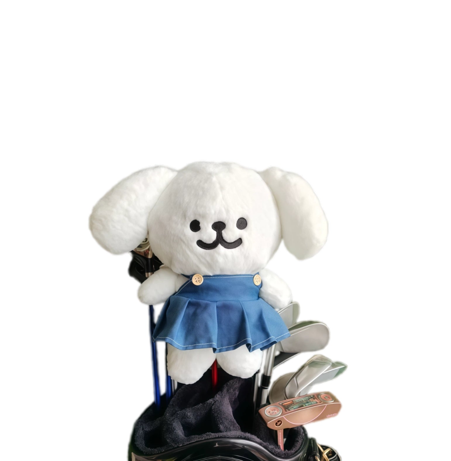 White puppy plush golf headcover dressed in a pleated blue skirt, fitted to a driver in a black tour cart bag