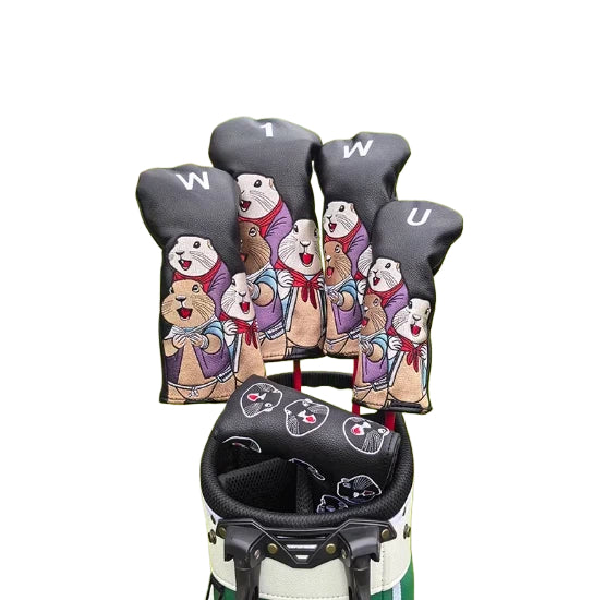 Back view of a black marmot golf headcover set with matching putter cover, showcasing detailed cartoon marmot designs and embroidered facial expressions, securely placed in a golf bag.