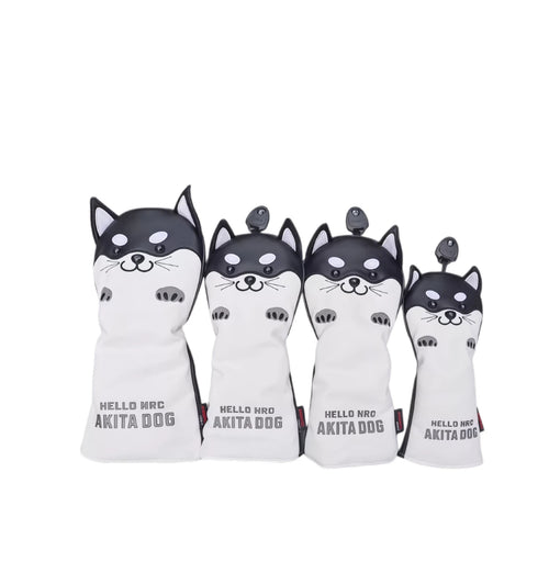 Front view of a four-piece black and white Akita Inu golf headcover set featuring cartoon-style dog faces with expressive eyes and paws, labeled "HELLO NRC AKITA DOG" — ideal for driver, fairway, hybrid, and utility clubs.