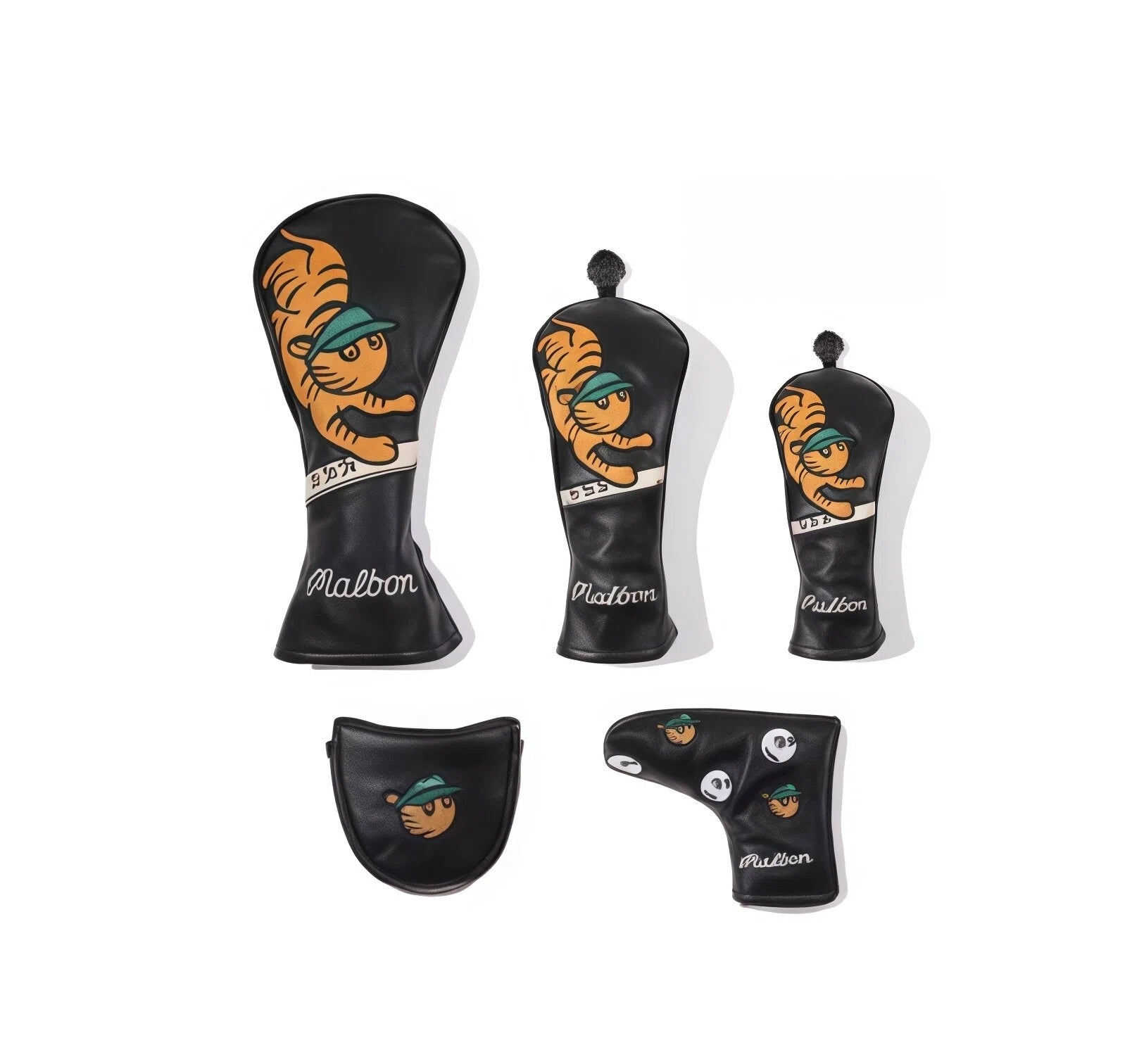 Full display of a complete Malbon golf headcover collection in black, featuring a classic tiger mascot with green cap on driver, fairway, hybrid, and two putter covers (blade and mallet).