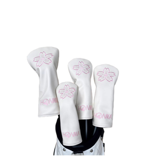 Set of HONMA golf club headcovers in white PU leather, featuring delicate pink sakura (cherry blossom) embroidery and "HONMA" branding, designed to protect your driver, fairway woods, and hybrids with a feminine and elegant touch.