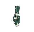  Front profile of the Malbon Golf Stand Bag in Hunter Green, highlighting the large "Malbon" typography, multiple storage pockets, and the unique dual hat holder accessory attached to the strap.
