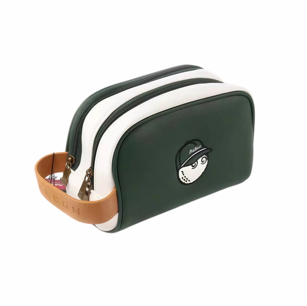 Side-angle view of Malbon Golf Buckets pouch in dark green PU leather showing dual zippers, white stitching, tan leather handle with debossed "MALBON", and cartoon golf ball mascot