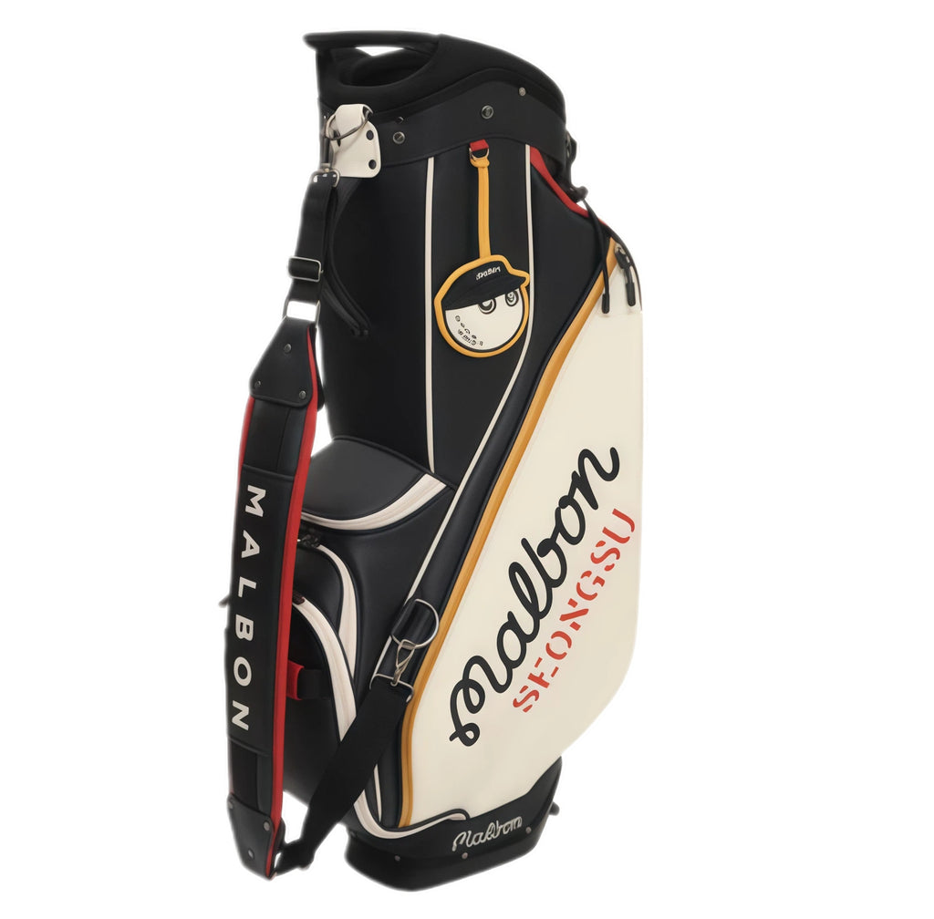 Close-up front view of Malbon Golf caddie bag highlighting the circular cartoon golf ball character patch, zippered pockets, dual-tone stitching, and "Malbon" script branding.