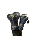 Malbon golf headcovers featuring yellow cartoon captain face logo and “Malbon Golf and Yacht Club” text, fitted on driver and fairway woods in a black golf bag.