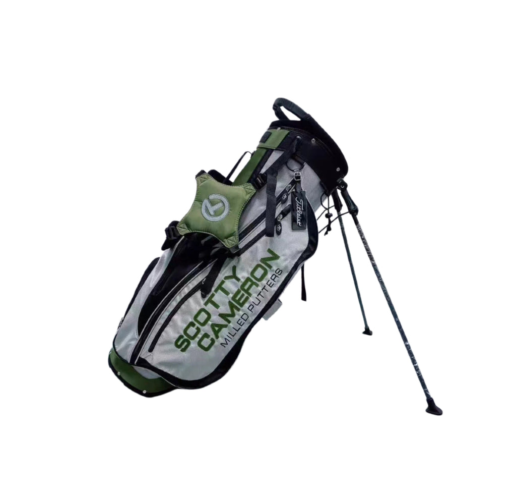 Side profile of the Scotty Cameron Pathfinder Golf Stand Bag in Gray/Green, highlighting the "SCOTTY CAMERON" branding, Titleist tag, and durable construction with integrated stand legs.