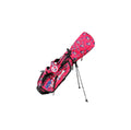 A Scotty Cameron Pathfinder Hometeam Stand Bag in a vibrant pink color. It features a patriotic pattern of American flags and stars, the "Circle T" logo, and is shown on its stand against a white background.