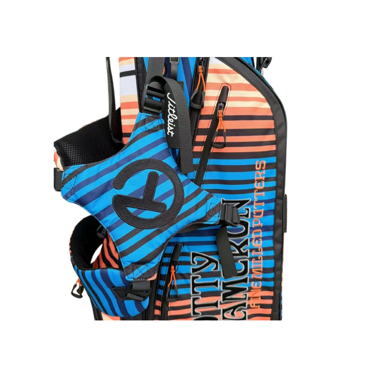 A close-up shot of the Scotty Cameron Pathfinder bag, focusing on the large black Circle T logo on the pocket and the vertical "SCOTTY CAMERON FINE MILLED PUTTERS" text on the side.
