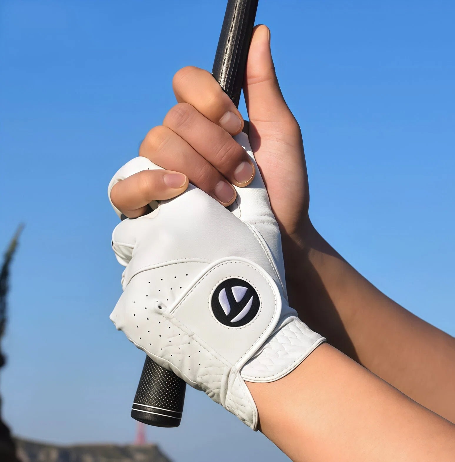 Golfer gripping a club wearing the TaylorMade N65445 glove, highlighting the snug fit, flexibility across the knuckles, and superior traction on the grip.