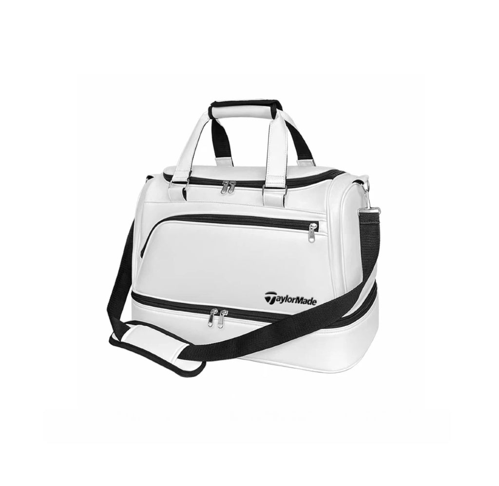 Side view of the white TaylorMade TM24 Authentic Boston bag featuring an adjustable black shoulder strap and padded carry handles. Ideal for comfortable carrying during travel, practice, or weekend golf outings.