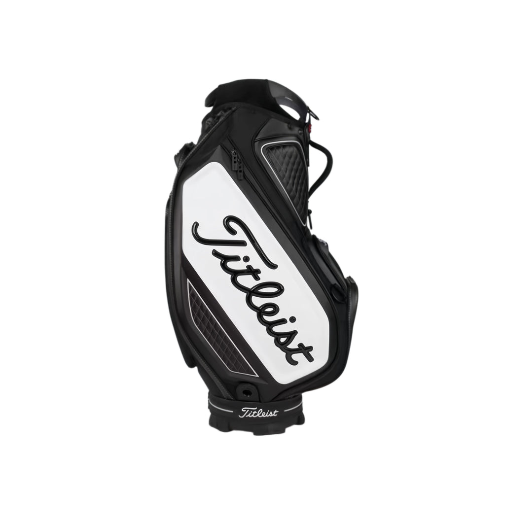 Back view of the Titleist Tour golf bag in black and white, featuring a large white panel with the iconic "Titleist" script logo in black. Includes ventilation zones, quilted padding, and a structured design for maximum protection and style.
